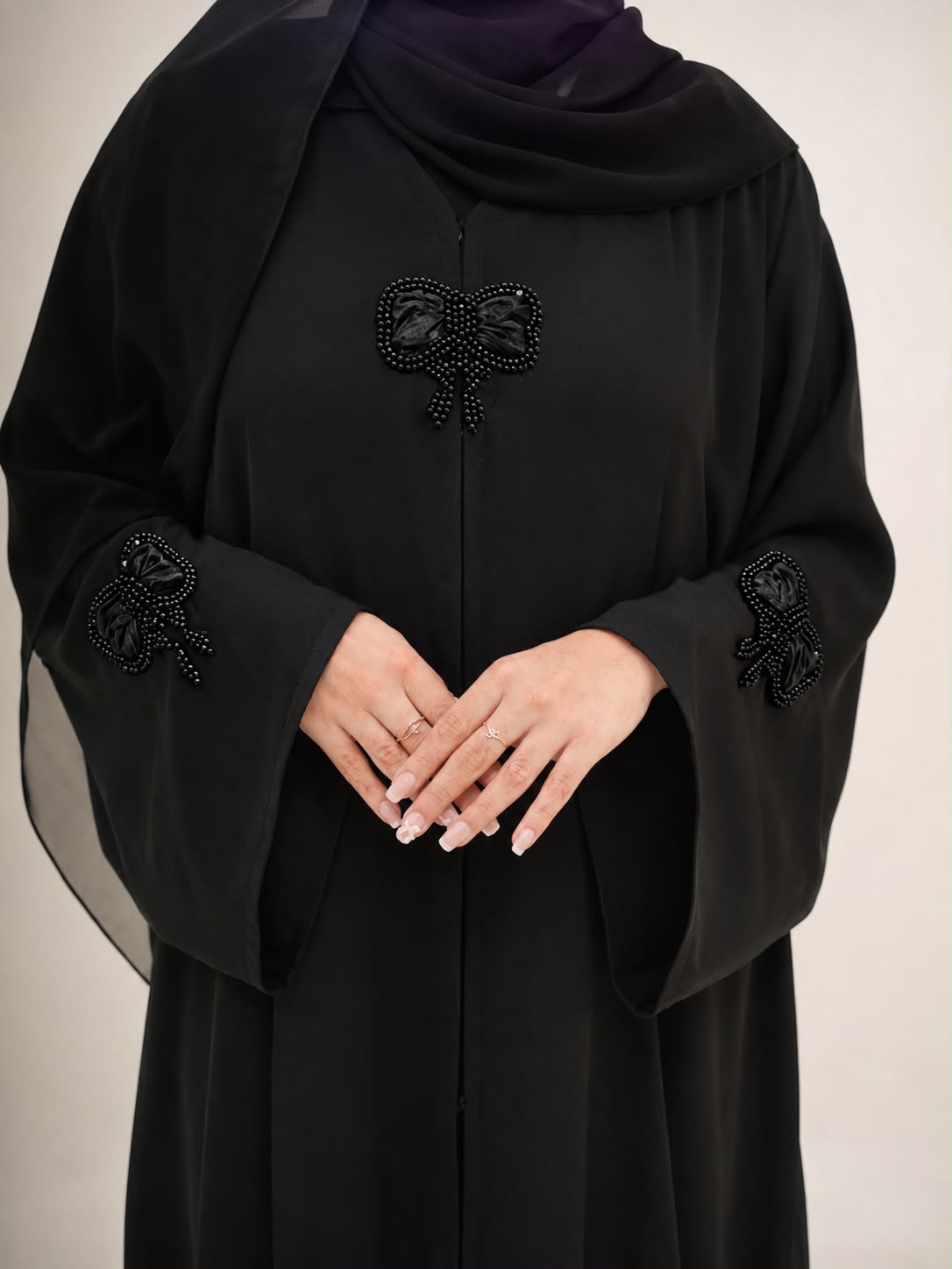 Close detail of the Layl Bow Abaya sleeve and beaded bow embellishment