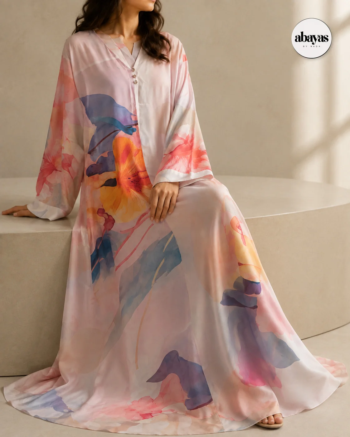 Seated editorial view of the Petal Print Abaya