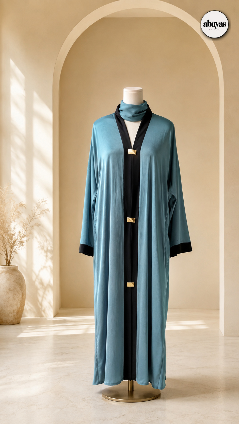 Tide Contrast Abaya on a mannequin beneath an arch